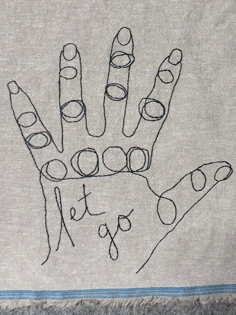 A line drawing of an outstretched hand on natural linen, with circles outlined on each fingertip and the words “let go” written in script across the palm.